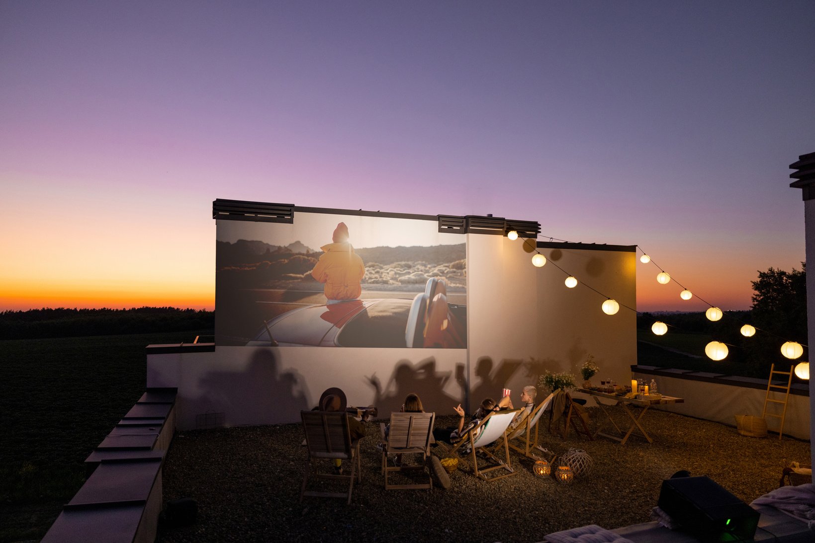 Friends Watching a Film Outdoors